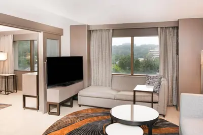 a living room with a couch and a tv at Pittsburgh Airport Marriott in Robinson Township