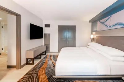 a bedroom with a large white bed and a television at Pittsburgh Airport Marriott in Robinson Township