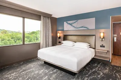 a bedroom with a large bed and a large window at Pittsburgh Airport Marriott in Robinson Township