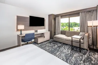 a hotel room with a couch and a tv at Pittsburgh Airport Marriott in Robinson Township