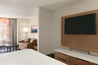 a hotel room with a bed and a flat screen tv at Fairfield Inn & Suites Wheeling - St. Clairsville, OH in Saint Clairsville