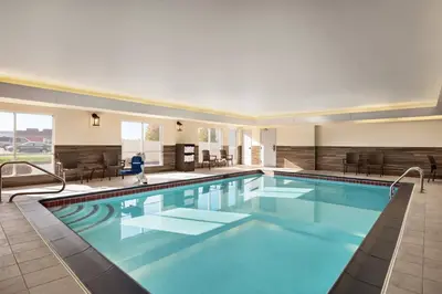 a large pool with blue water in a hotel at Fairfield Inn & Suites Wheeling - St. Clairsville, OH in Saint Clairsville