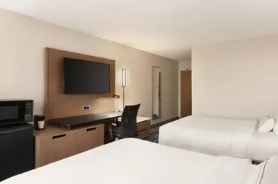 a hotel room with two beds and a desk with a television at Fairfield Inn & Suites Wheeling - St. Clairsville, OH in Saint Clairsville