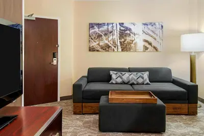 a living room with a couch and a table at SpringHill Suites by Marriott Wheeling Triadelphia Area in Wheeling