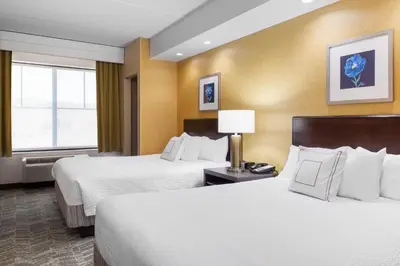 a hotel room with two beds and a window at SpringHill Suites by Marriott Wheeling Triadelphia Area in Wheeling