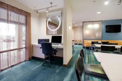 an office with a waiting room with a desk and chairs at SpringHill Suites by Marriott Pittsburgh Washington in Washington