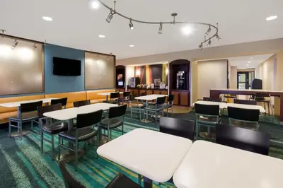 a conference room with tables and chairs and a tv at SpringHill Suites by Marriott Pittsburgh Washington in Washington