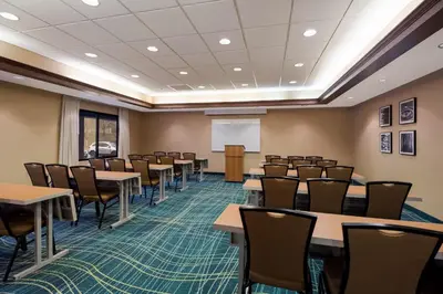 a conference room with tables and chairs and a podium at SpringHill Suites by Marriott Pittsburgh Washington in Washington