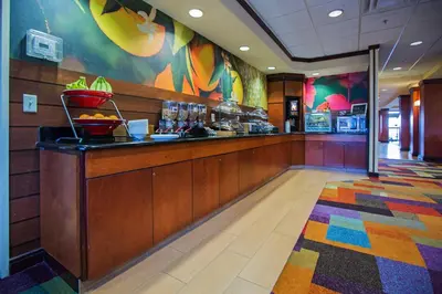 a restaurant with a counter and a buffet at Fairfield Inn & Suites Toledo North in Toledo