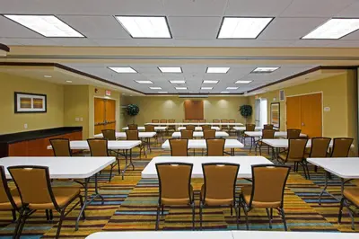 a conference room with tables and chairs in it at Fairfield Inn & Suites Toledo North in Toledo
