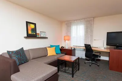 a living room with a couch and a desk at Residence Inn Toledo Maumee in Maumee