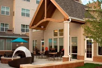 a patio with awning and tables and chairs at Residence Inn Toledo Maumee in Maumee