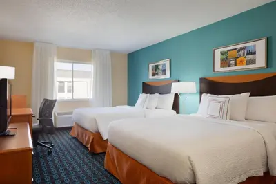a hotel room with two beds and a television at Fairfield Inn & Suites Youngstown Boardman Poland in Poland