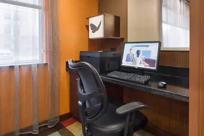 a computer sitting on a desk with a chair at Fairfield Inn & Suites Youngstown Boardman Poland in Poland