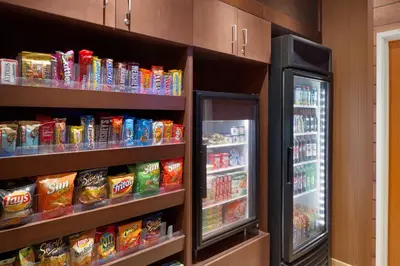 a refrigerator and shelves filled with food and snacks at Fairfield Inn & Suites Youngstown Boardman Poland in Poland