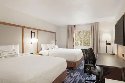 a hotel room with two beds and a desk at Fairfield Inn by Marriott Warren Niles in Warren