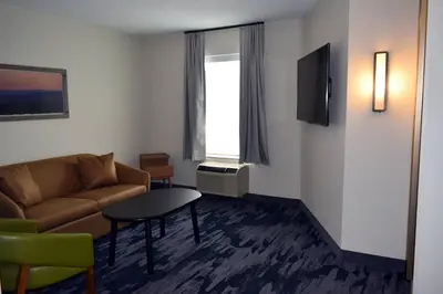 a living room with a couch and a table at Fairfield by Marriott Youngstown/Austintown in Youngstown