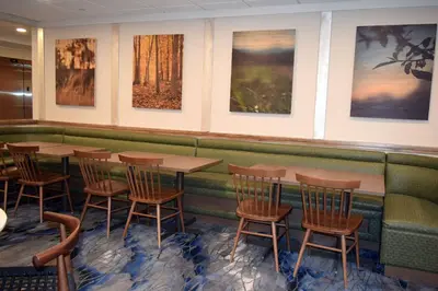 a restaurant with tables and chairs and pictures on the wall at Fairfield by Marriott Youngstown/Austintown in Youngstown
