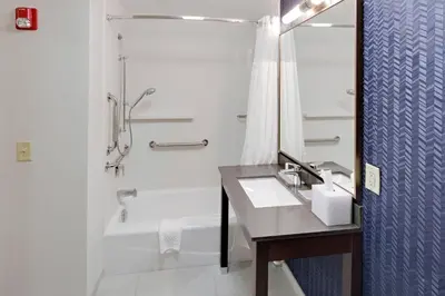 a bathroom with a sink and a tub and a shower at Fairfield by Marriott Youngstown/Austintown in Youngstown