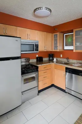 a kitchen with stainless steel appliances and wooden cabinets at Residence Inn Youngstown Boardman/Poland in Poland