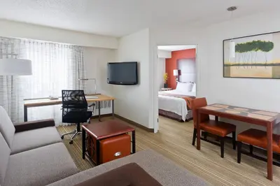 a hotel room with a room with a bed and a desk at Residence Inn Youngstown Boardman/Poland in Poland