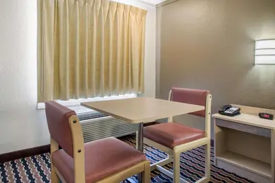 a small room with a table and two chairs at Rodeway Inn Sharonville - Cincinnati North in Sharonville