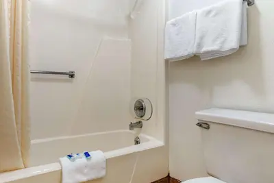 a bathroom with a tub and a toilet and a shower at Rodeway Inn Sharonville - Cincinnati North in Sharonville