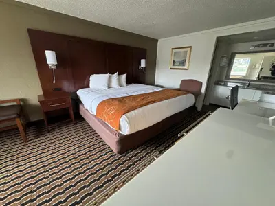 a hotel room with a bed and a desk at Rodeway Inn Sharonville - Cincinnati North in Sharonville