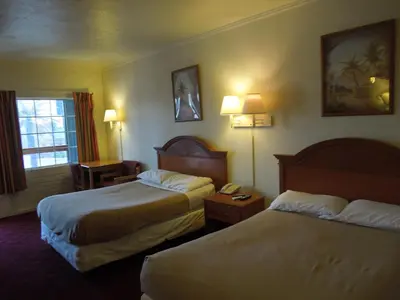 a hotel room with two beds and a telephone at Wildwood Inn in Florence