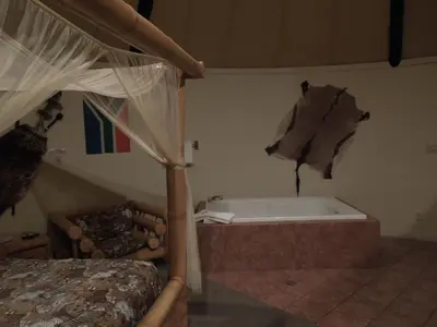 a bedroom with a bed and a bath tub at Wildwood Inn in Florence
