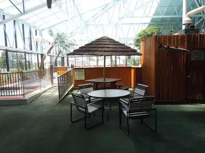 a table and chairs with an umbrella in a building at Wildwood Inn in Florence