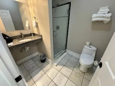 a bathroom with a toilet and a sink and a shower at The Sherman Inn in Batesville