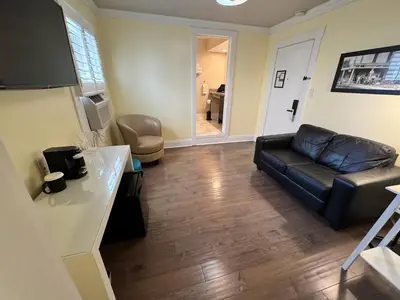 a living room with a leather couch and a chair at The Sherman Inn in Batesville