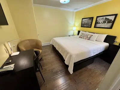 a hotel room with a bed and a desk at The Sherman Inn in Batesville