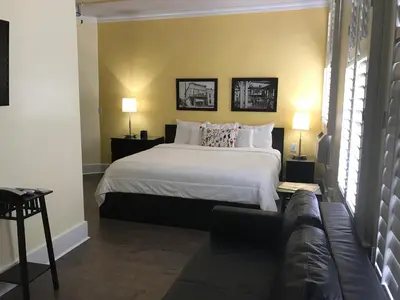 a bedroom with a large bed and a couch at The Sherman Inn in Batesville