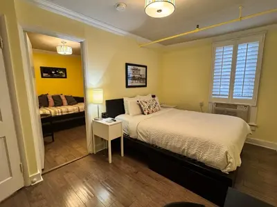a bedroom with a large bed and a bed sidx sidx sidx sidx at The Sherman Inn in Batesville