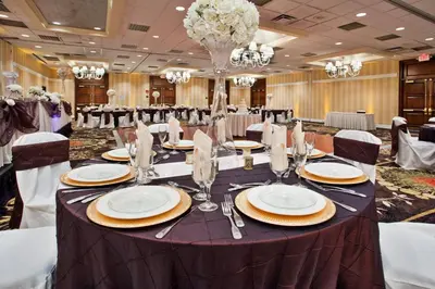 a long table in a banquet hall with tables and chairs at Ramada by Wyndham Cleveland Independence in Independence