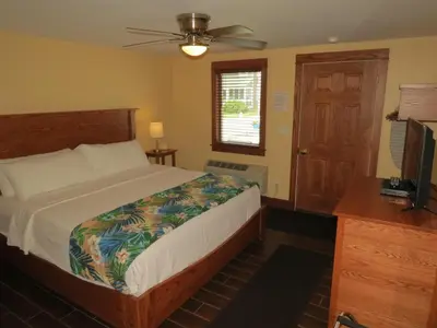 a bedroom with a bed and a ceiling fan at Bodee's Bungalow Adults Only Couples Only Boutique Hotel in Put-in-Bay