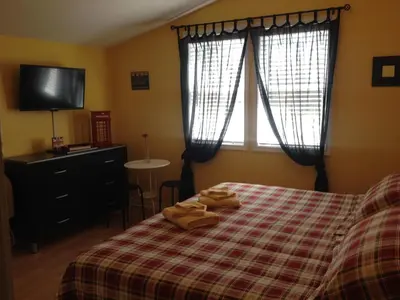 a bedroom with a bed with two towels on it at Ahoy Inn Guesthouse in Put-in-Bay