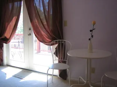 a room with a table and a table and a window at Ahoy Inn Guesthouse in Put-in-Bay