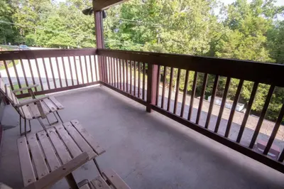 a wooden bench sitting on a screened in porch at Carter Caves State Resort Park in Olive Hill