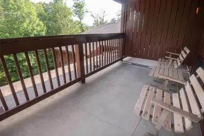 a porch with two wooden benches on a deck at Carter Caves State Resort Park in Olive Hill