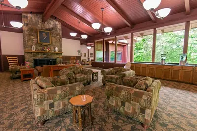 a large living room with couches and a fireplace at Carter Caves State Resort Park in Olive Hill