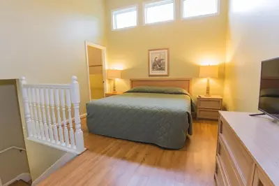 a bedroom with a bed and a tv in it at General Butler State Resort Park in Carrollton
