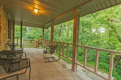 a screened porch with chairs and tables on it at General Butler State Resort Park in Carrollton