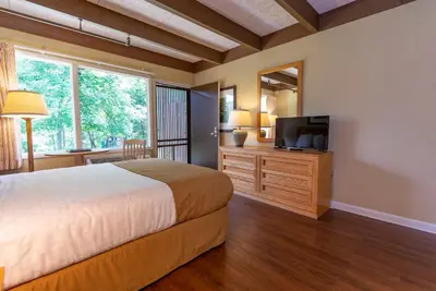 a bedroom with a bed and a flat screen tv at Greenbo Lake State Resort Park in Argillite