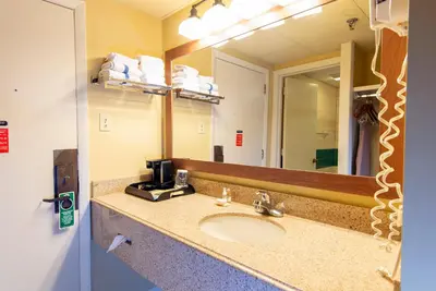 a bathroom with a sink and a mirror at Greenbo Lake State Resort Park in Argillite