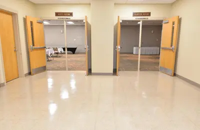 an empty room with doors and a room with tables at Greenbo Lake State Resort Park in Argillite
