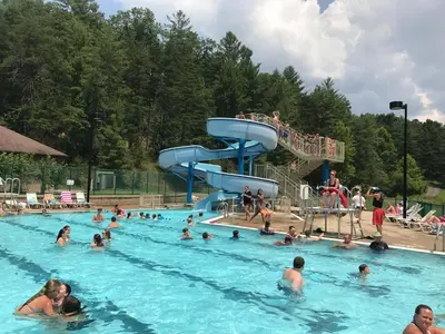 a group of people swimming in a swimming pool at Greenbo Lake State Resort Park in Argillite