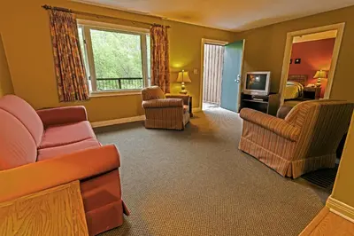 a living room with a couch and chairs and a television at Blue Licks Battlefield State Park in Carlisle
